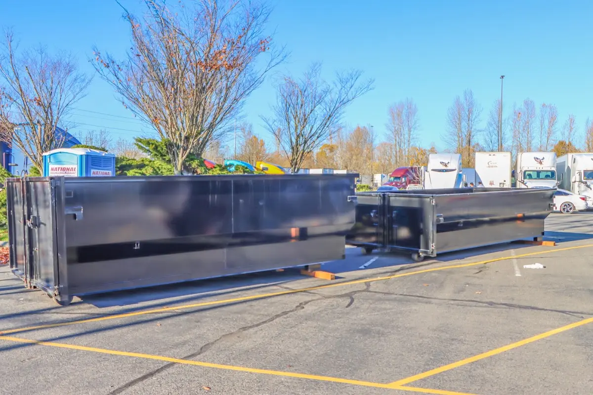 Professional dumpster rental service with roll-off container on residential driveway in Bemidji